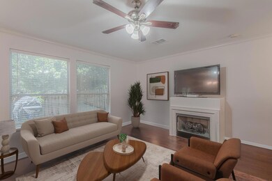 Living area with ceiling fan, plenty of natural l