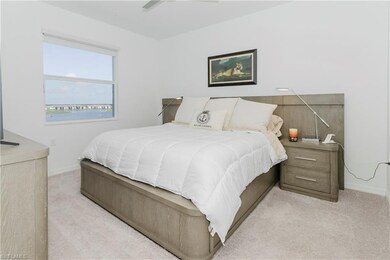 Bedroom featuring light colored carpet and baseboards