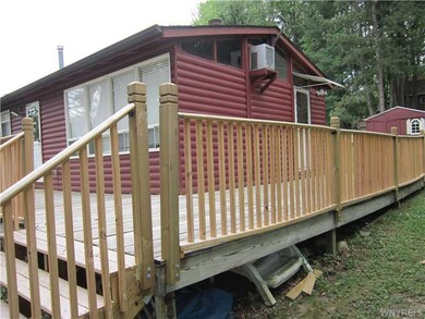 Exterior Front. Side view of the wrap-around deck.