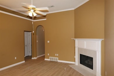 Unfurnished living room with visible vents, arched
