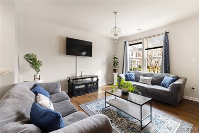 Living room with dark wood-type flooring and a cha
