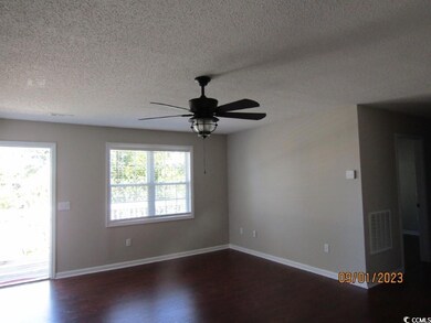 Unfurnished room with a textured ceiling, ceiling fan, and wood-type flooring