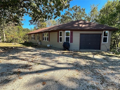View of property exterior featuring gravel driveway