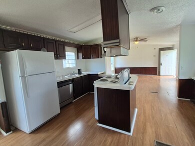 Kitchen includes fridge and electric stove