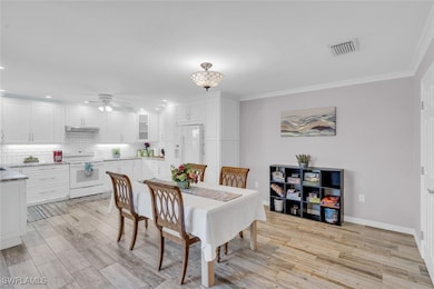 Dining room with a ceiling fan, ornamental molding