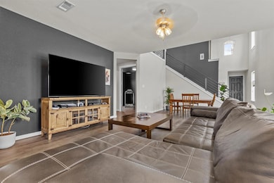 Living room with wood finished floors, stairway, 