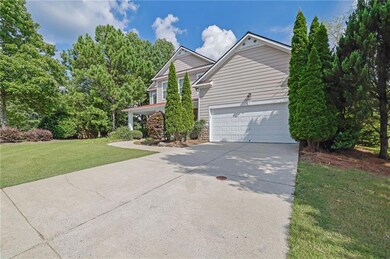 View of property exterior featuring concrete driveway and a yard