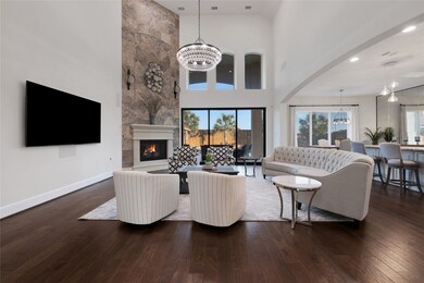 Living room w/fireplace w/tile to the ceiling.