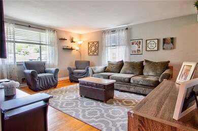 Living room with newer windows and hardwood floori