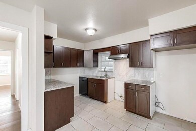 Kitchen with sink, tasteful backsplash, light tile