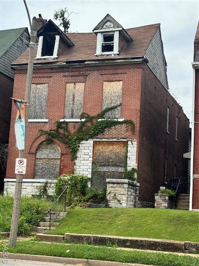 View of front of home with stone siding, brick siding, a chimney, and a front yard