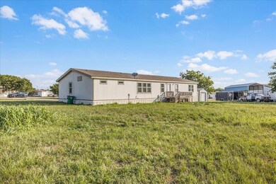 Back of property with an outdoor structure and a y
