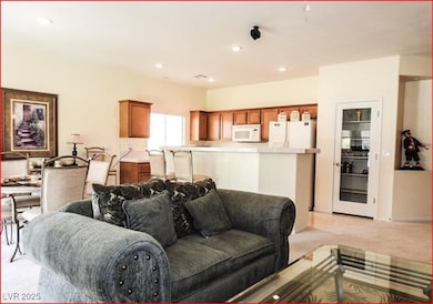Living room with light colored carpet and recessed