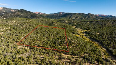 Aerial view of property's location featuring a mountainous background and property boundaries highlighted