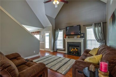 Open Living Room with gas fireplace, hardwood floors and vaulted ceilings