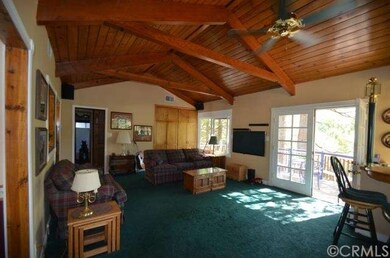 living room with open beamed ceilings, French door