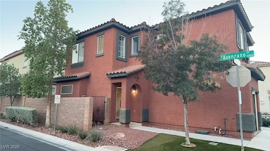 Mediterranean / spanish-style home with a tile roof, stucco siding, a fenced front yard, and a gate