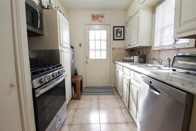 VIEW OF KITCHEN FROM DINING AREA.