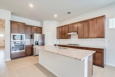 Kitchen with stainless steel appliances, a sink, 
