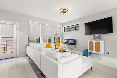 Living area featuring wood finished floors and ba