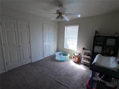 Playroom featuring a ceiling fan and carpet floors
