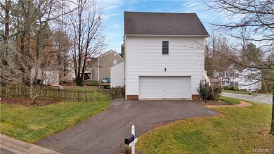 View of side of home with a lawn and a garage