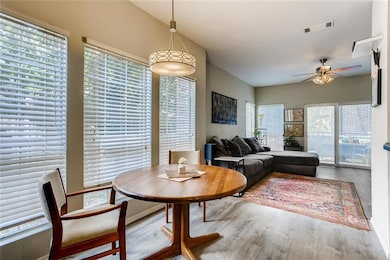 Dining space with wood finished floors, ceiling f