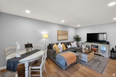 Living area with recessed lighting and light wood-style flooring
