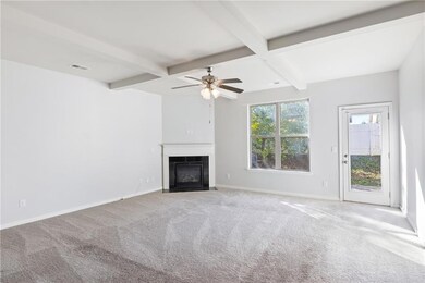 Unfurnished living room featuring beamed ceiling, 