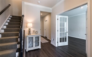 Foyer accented w/crown molding.