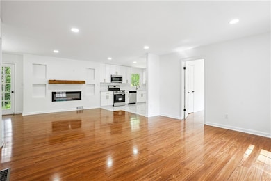 Unfurnished living room featuring light wood-style