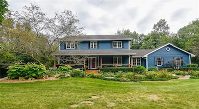 Front of home with extensive landscaping and woode