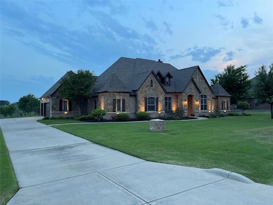 Home featuring decorative stone exterior walls, a 