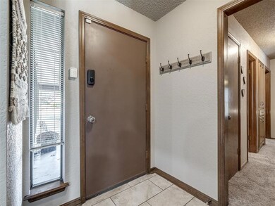 Doorway to outside with light tile patterned floor