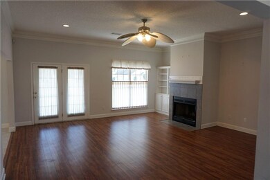 Family room with wood burning fireplace. French do