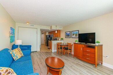 Living room with light wood finished floors and a textured ceiling