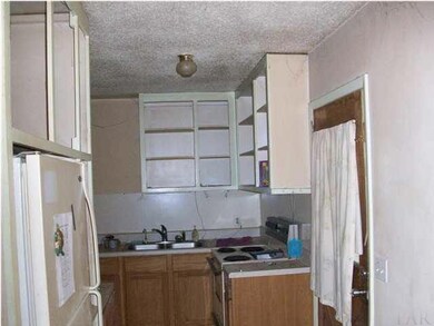 VIEW OF KITCHEN, REFRIGERATOR ON LEFT.