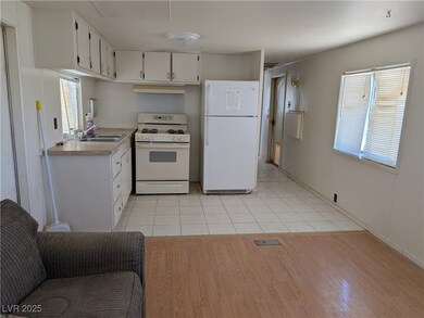Kitchen featuring white appliances, white cabinetr