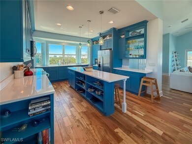 Kitchen featuring open shelves, blue cabinets, vis