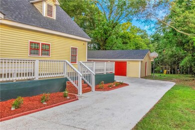 View of front facade with a wooden deck and an out