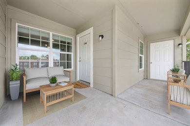 This inviting patio space features the front door