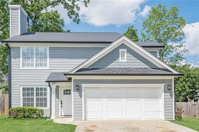 View of front of property with fence, concrete dri