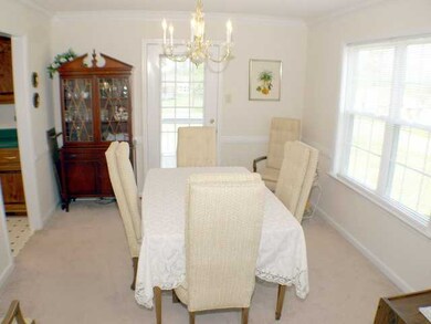 Bright and inviting Dining Room boasts chair rail 