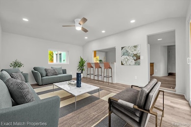Living room with recessed lighting, light wood-type flooring, and ceiling fan