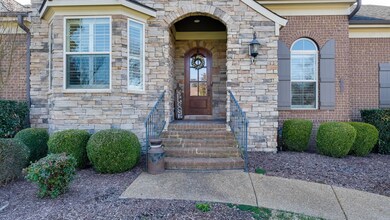 The quaint, arched front porch greets you as you first arrive and provides the perfect introduction to the warm, inviting open-concept living area.  