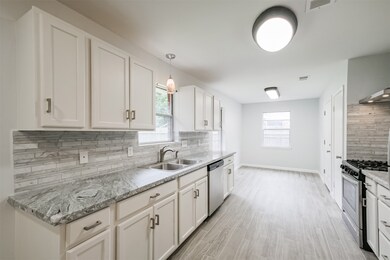 Updated granite counter tops, new cabinetry, new lighting, and new appliances are some of the updates in the kitchen.