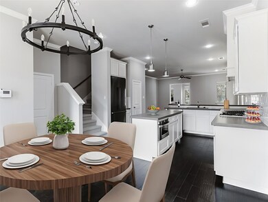 Kitchen featuring crown molding, white cabinets, a center island, dark wood-style floors, and appliances with stainless steel finishes