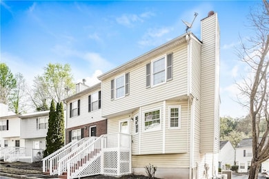 Townhome / multi-family property featuring a chimn