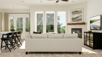 Living room featuring ceiling fan, a fireplace, an