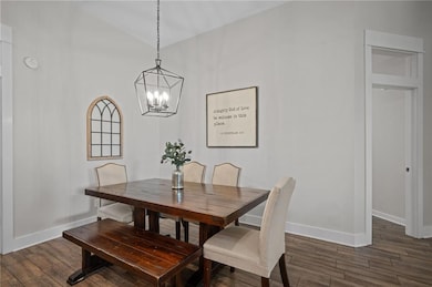 Dining room featuring dark wood-style floors, a ch